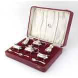 Silver six piece cruet with blue glass liners, hallmarked Birmingham 1968, housed in a velvet and