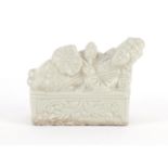 Chinese white glazed stoneware brush rest in the form of a reclining female, 10.5cm wide :For