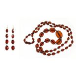 Cherry amber coloured faceted bead necklace and earrings, the necklace 84cm long, 51.6g :For Further