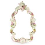 Continental floral encrusted porcelain cartouche mirror, hand painted and gilded with C scrolls,