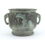 Chinese archaic style patinated bronze planter with elephant head handles, cast with panels of birds