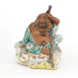 Chinese porcelain Buddha, hand painted with flowers, impressed marks to the base, 20cm high :For