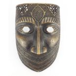 Good antique Persian bronze war mask, finely engraved with flowers and calligraphy, 24cm high :For