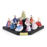 Eleven Royal Doulton figurines with hardwood display stand, each 6cm high :For Further Condition