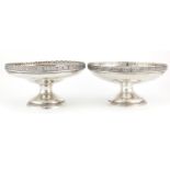 Two circular silver pedestal dishes with pierced floral borders, one by Mappin & Webb London 1922
