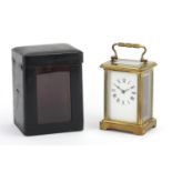 French brass cased carriage clock with travelling case, the clock with enamelled dial and Roman