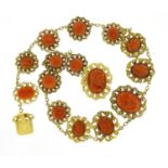 18th/19th century unmarked gold coral necklace (tests as 9ct), with 15 coral panels each carved with