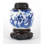 Chinese blue and white ginger jar with carved hardwood lid on stand, the ginger jar hand painted