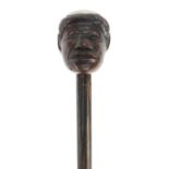 Ebonised walking stick with carved head pommel and silver coloured metal mounts engraved FVL LT,