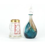 Mdina twisted glass bottle with stopper and a Bohemian red flashed and cut glass tankard, the