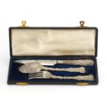 Good 19th century silver knife, fork and spoon Christening set, with fruiting vines, by William