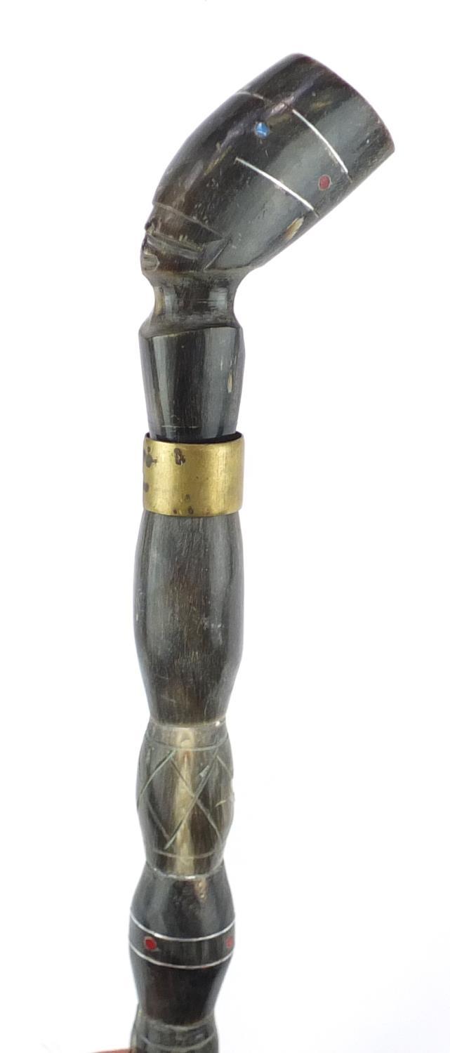 Segmented horn walking stick with figural pommel, 94cm in length :For Further Condition Reports