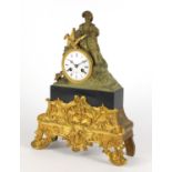 19th century French ormolu mantel clock, mounted with a man his dog, the enamelled dial with Roan