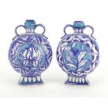 Pair of Islamic pottery vases with twin handles, hand painted with flowers, each 15.5cm high :For