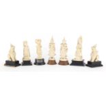 Indian ivory carvings including two dancers and a pair of lions, each raised on wood stands, the