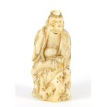 Good Japanese carved ivory netsuke of a man seated on a rock, 5.2cm high :For Further Condition