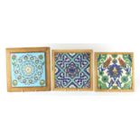 Three Turkish pottery tiles including a Kutahya example, hand painted with flowers, each framed,