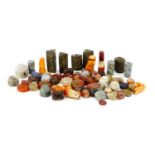 Collection of beads and stones including Islamic carved agate examples, the largest approximately