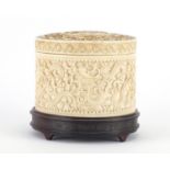 Chinese Canton ivory pot and cover, finely carved with dragons amongst clouds, raised on a carved