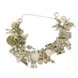 Heavy silver charm bracelet with a large selection of mostly silver charms, 105.0g :For Further
