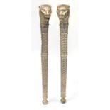 Pair of silvered metal lion head torch design columns, each 104cm in length :For Further Condition