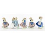 Five Lladro and Nao figures including a young boy and girl seated on a bench, the largest 16.5cm