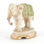 Hand painted porcelain elephant, possibly Royal Dux, impressed 1014 to the base, 16.5cm high :For