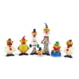 Seven Murano colourful glass clowns and a group of glass sweets, the largest 32cm high :For