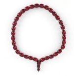 Islamic cherry amber coloured bead prayer necklace, overall 49cm in length, the largest bead