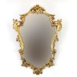 Ornate gilt framed cartouche shaped mirror, 74cm x 54cm :For Further Condition Reports Please
