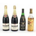 Four vintage bottles of alcohol comprising White Horse scotch whisky, two bottles of 1965 Pomagne