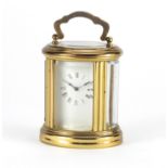 Miniature brass cased oval carriage clock, the dial having Roman numerals, impressed LD to the