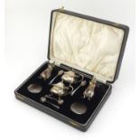 Silver four piece cruet by Henry Clifford Davis, housed in a fitted tooled leather box, the
