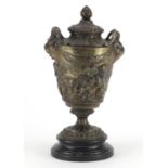 19th century classical patinated bronze urn and cover with rams head handles, cast in relief with