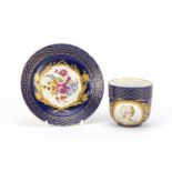 19th century Sèvres blue ground portrait cup and saucer with jewelled decoration, the cup 7cm