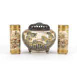 Japanese Satsuma pottery comprising a pair of three footed vases, hand painted with figures and