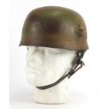 German Military interest tin helmet with decal and leather liner, stamped marks to the interior :For