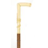 Palmwood walking stick with bone handle carved with a serpent, possibly whale bone, 97cm in