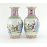 Pair of Chinese porcelain vases, each finely hand painted in the famille rose palette with figures