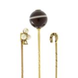 Three Victorian unmarked gold tie pins including diamond and sapphire, diamond and pearl and