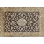 Rectangular Persian silk rug having an all over floral design onto a midnight blue ground, 160cm x