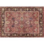 Rectangular Indian rug having an all over floral design onto a red ground, 223cm x 155cm :For