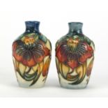 Pair of Moorcroft pottery vases hand painted with stylised flowers, each 9.5cm high :For Further