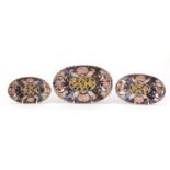 Gradated set of three Japanese Imari porcelain fluted dishes, each hand painted with flowers,
