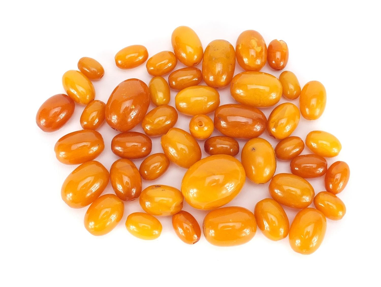 Butterscotch amber coloured beads, the largest 2.8cm in length, 82.0g :For Further Condition Reports
