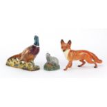Three Beswick animals pheasant comprising a fox badger and a badger decanter, the largest 23cm in