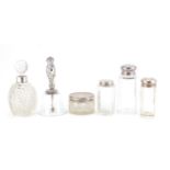 Five cut glass jars, bottles and a table bell, all with silver mounts, various hallmarks, the