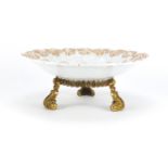 19th century Meissen porcelain dish, decorated in relief with flowers, raised on an ormolu stand,