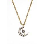 Unmarked gold diamond moon crest pendant on a 9ct gold necklace, the pendant 1.5cm in length, 4.