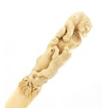 Good 19th century ivory page turner, the handle finely carved with two bears climbing a trunk for